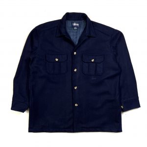 a vintage stussy navy button jacket with pocket on the front