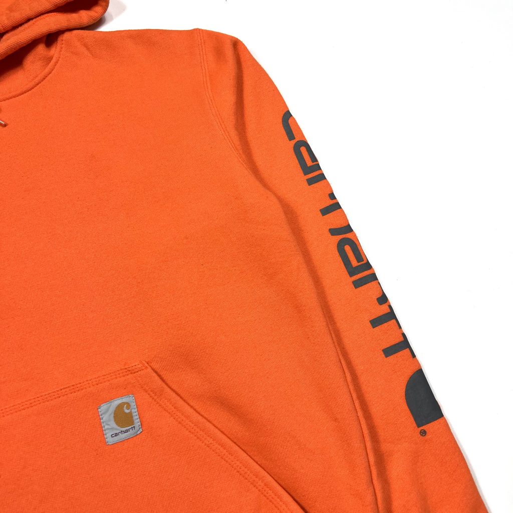 vintage carhartt orange hoodie with printed logo on the sleeve