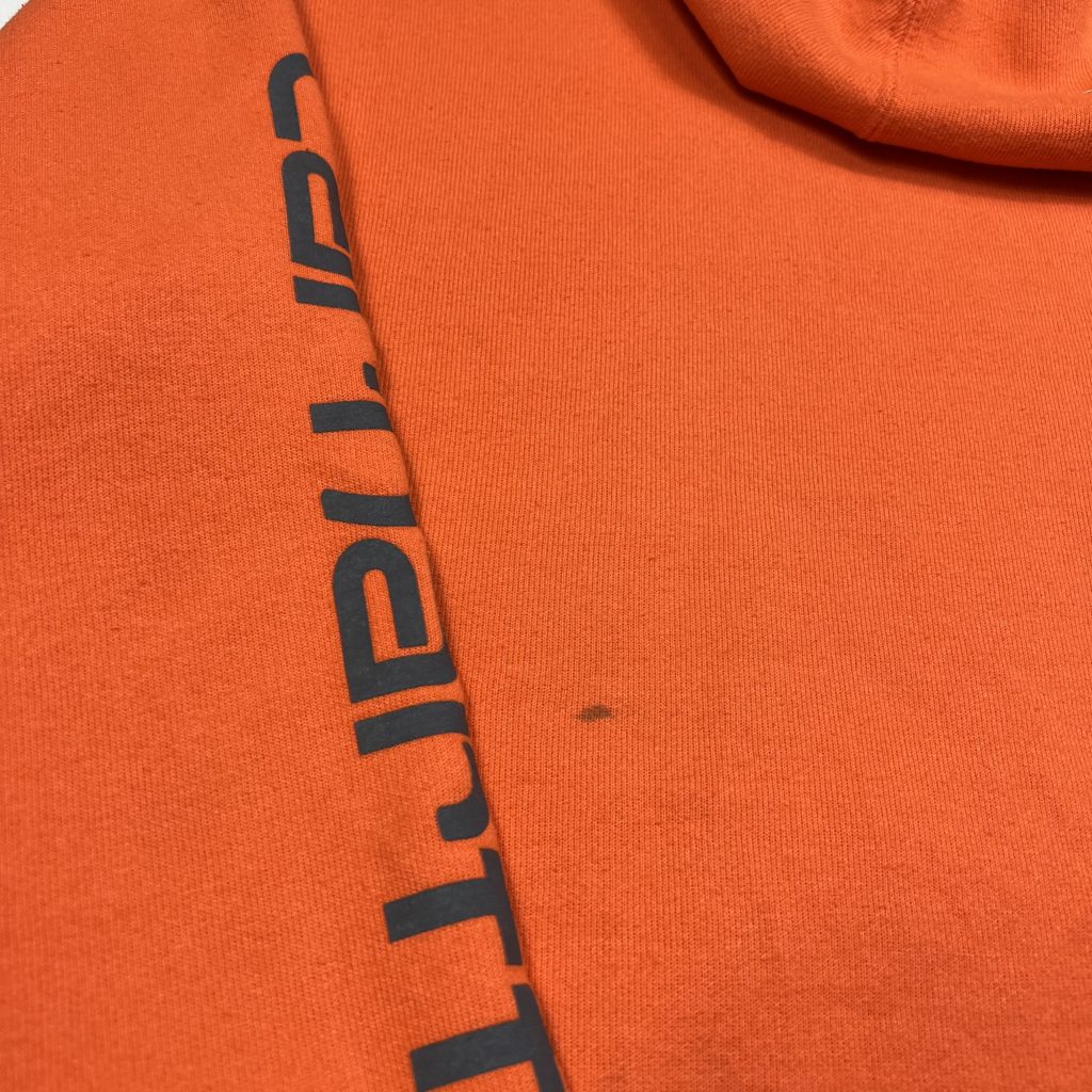 vintage carhartt orange hoodie with printed logo on the sleeve