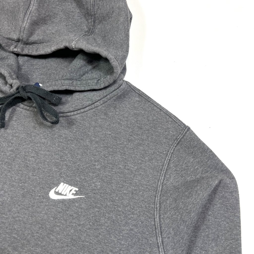 a vintage nike grey essentials hoodie with white embroidered logo
