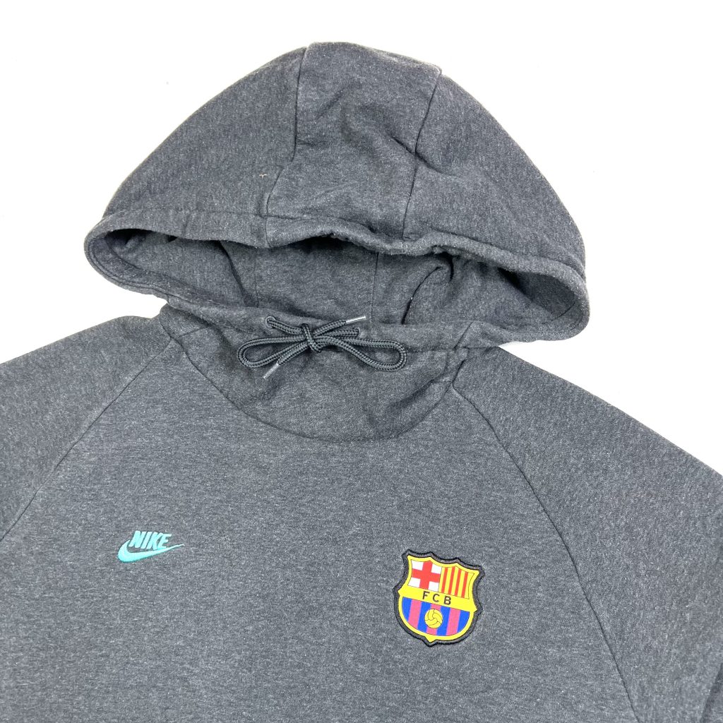 a vintage grey nike hoodie with embroidered barcelona fc badge