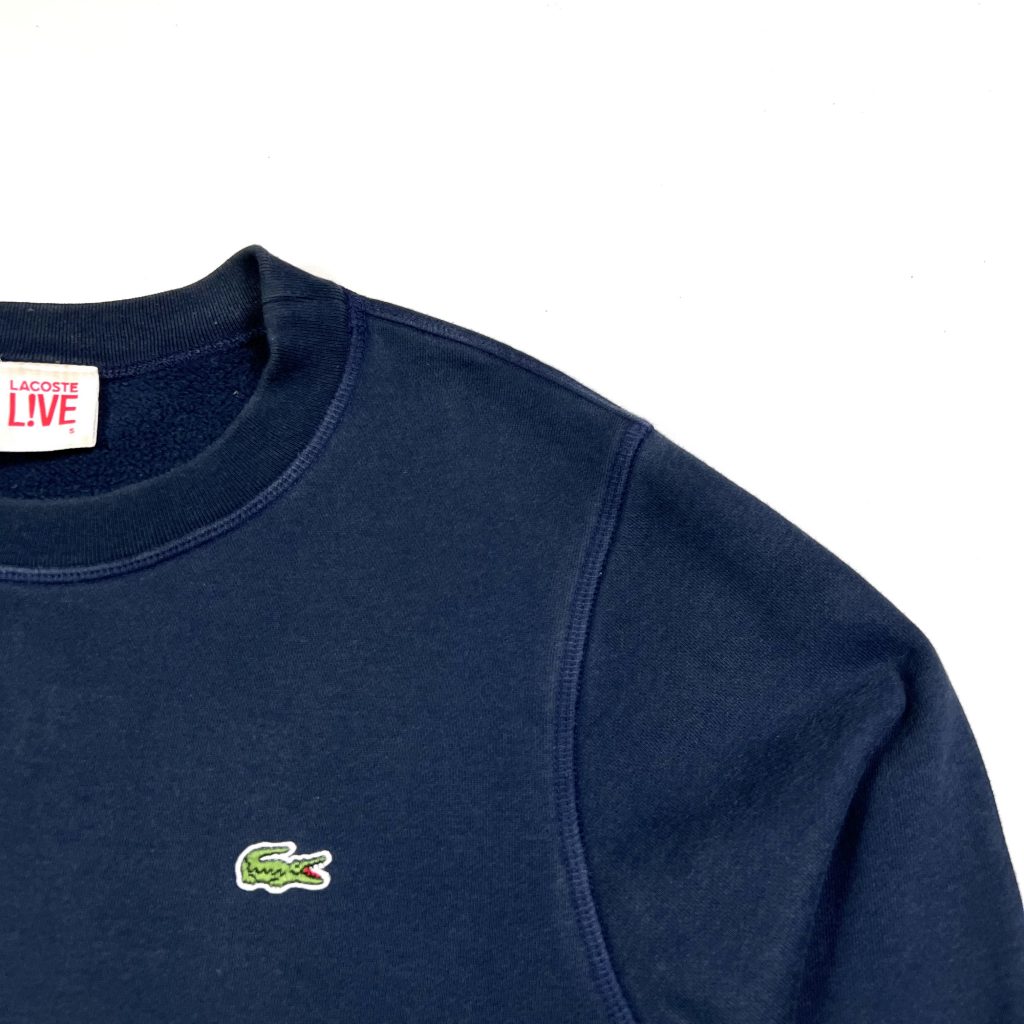 a vintage lacoste live navy sweatshirt with patterned hem and cuff