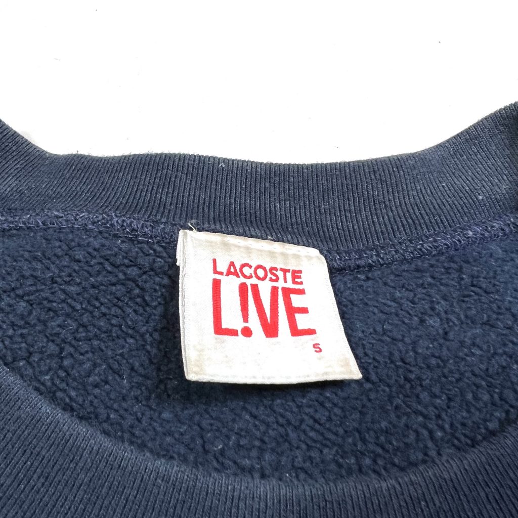 a vintage lacoste live navy sweatshirt with patterned hem and cuff