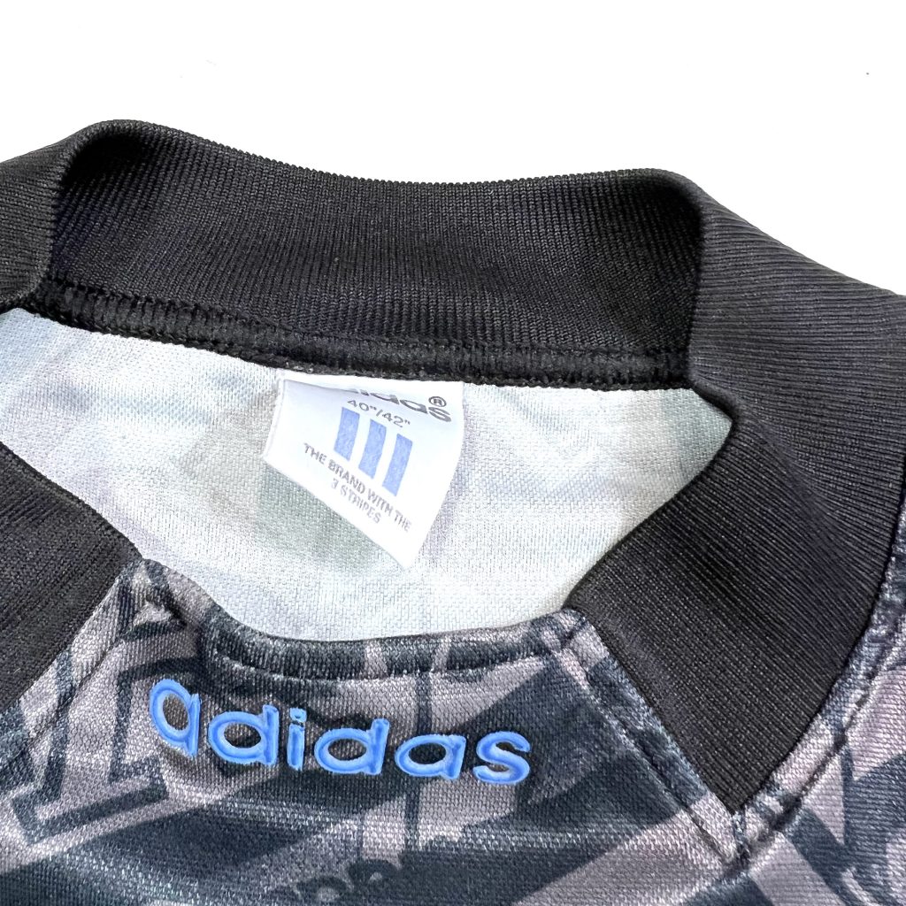 adidas linear logo on the collar of a vintage adidas t-shirt