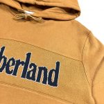 a mens timerland mustard coloured hoodie with knitted logo