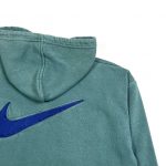 big embroidered swoosh logo on the back of green hoodie