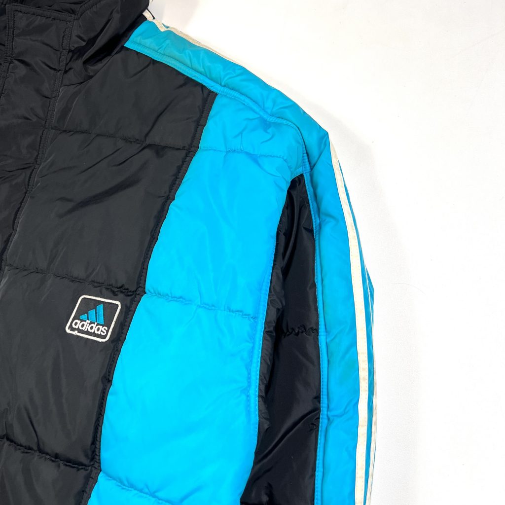 a black vintage adidas puffer jacket with 3-stripes down the sleeves