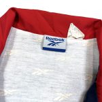 A navy Reebok vintage zip up track jacket
