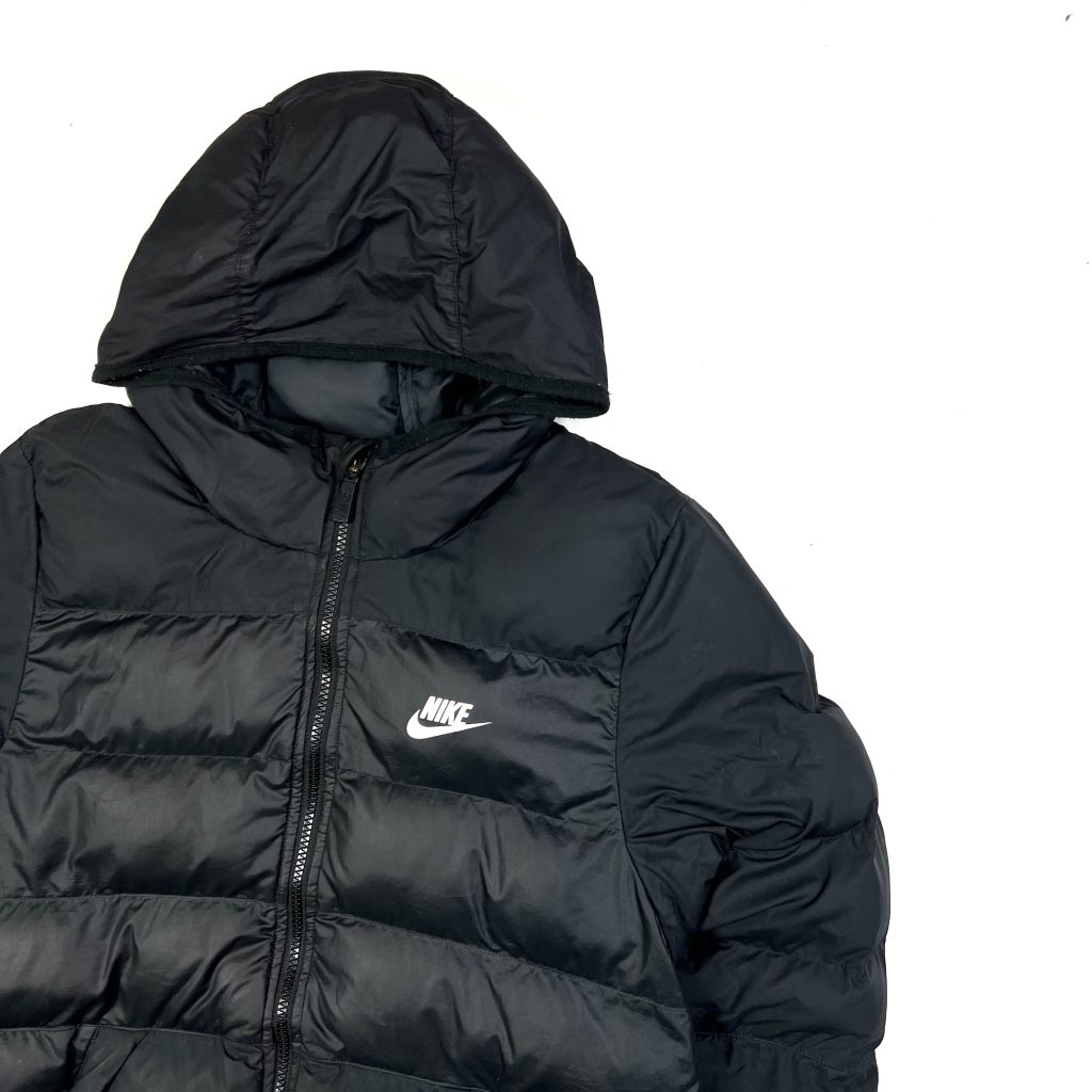 a black nike puffer jacket with hood