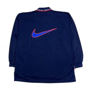 big embroidered swoosh logo on the back of a blue nike polo sweatshirt