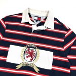 embroidered tommy hilfiger crest logo on the front of a navy rugby shirt