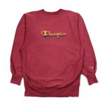 a red champion vintage sweatshirt with embroidered script logo