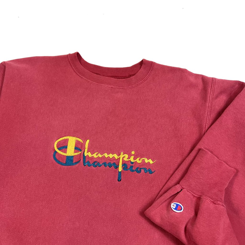 embroidered champion script logo on vintage red champion sweatshirt