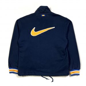 a vintage 90’s navy nike zip jacket with big yellow embroidered swoosh logo
